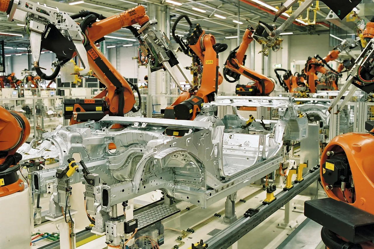 Humanoid robot working inside an automotive factory.